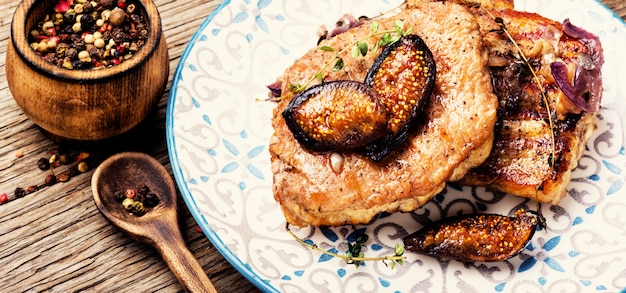 Meat steak with figs on plate