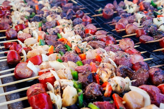 Meat and vegetables brochettes or anticucho on the grillxA