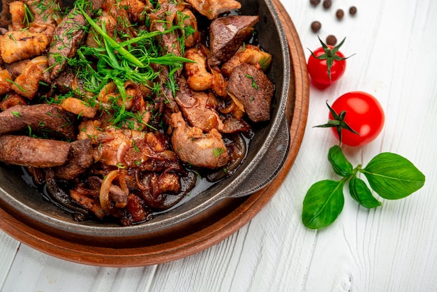 Meat and vegetables in frying pan