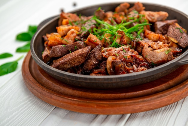 Meat and vegetables in frying pan