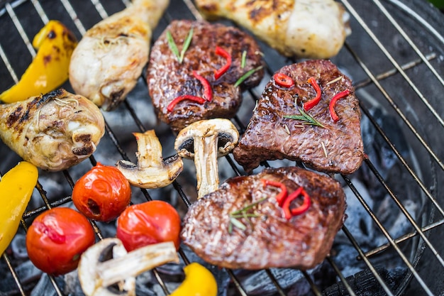 Meat and vegetables on grill, close-up