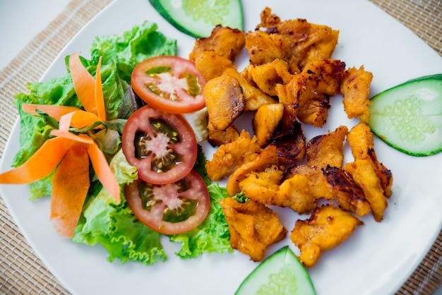 Meat with vegetables on a white plate. Restaurant.