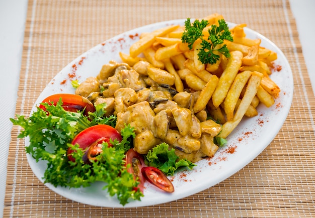 Meat with vegetables on a white plate. Restaurant.