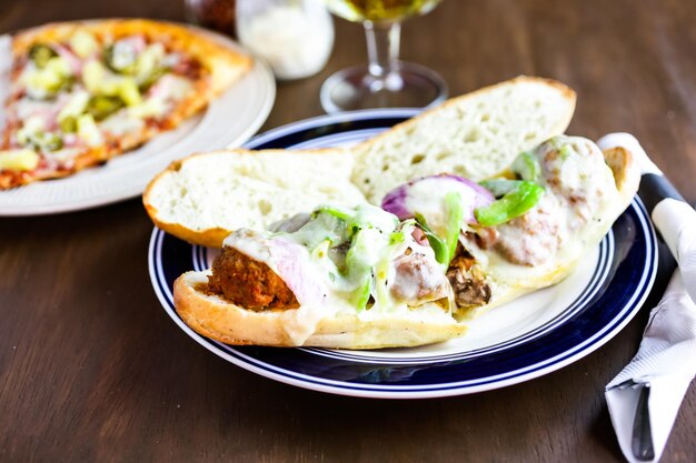 Meatball sandwich with sauce on the plate in Italian restaurant.