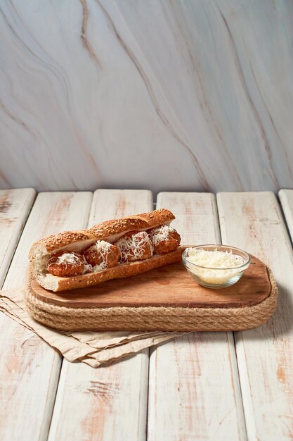 Meatball sandwich with tomato sauce and cheese on a hoagie roll