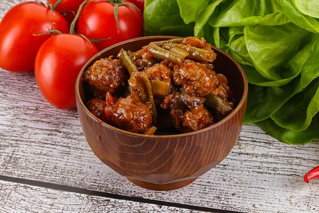 Meatball with vegetables and spices in the bowl