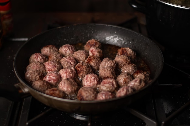 Meatballs in a frying pan Making meatballs Dark background