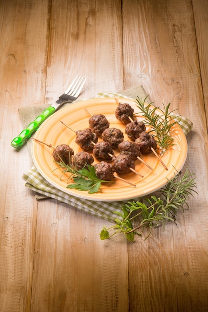 Meatballs skewers with herbs