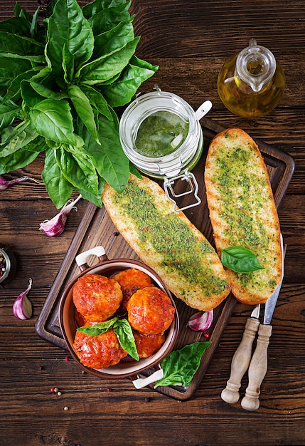 Meatballs in tomato sauce and toast with basil pesto. Dinner. Tasty food. Top view. Flat lay