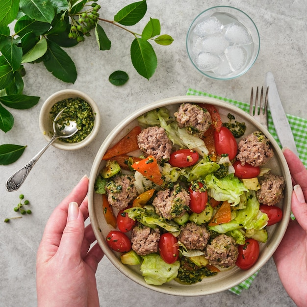 Meatballs with cherry tomatoes and salad.