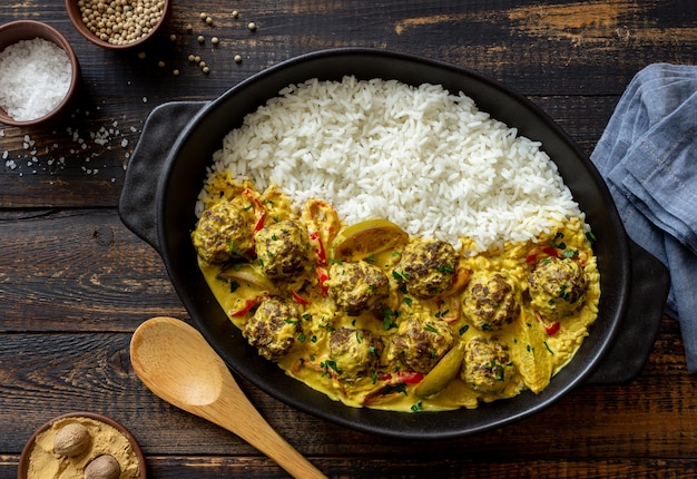 Meatballs with rice, curry sauce, lime and red pepper. Healthy eating.