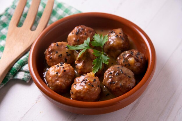 Meatballs with tomato sauce and vegetables. Traditional Spanish tapa.