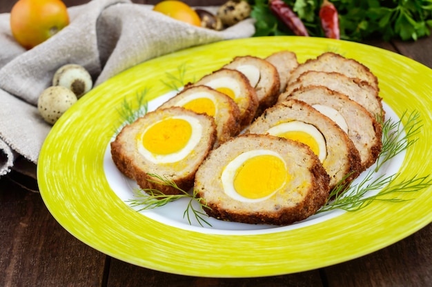 Meatloaf stuffed with boiled eggs on a plate