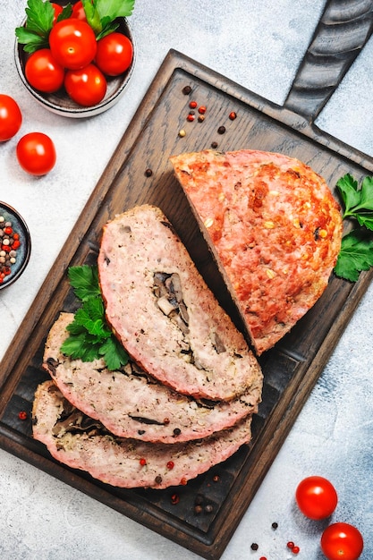 Meatloaf with mashrooms classic american food with baked pork beef minced meat on cutting board Top view