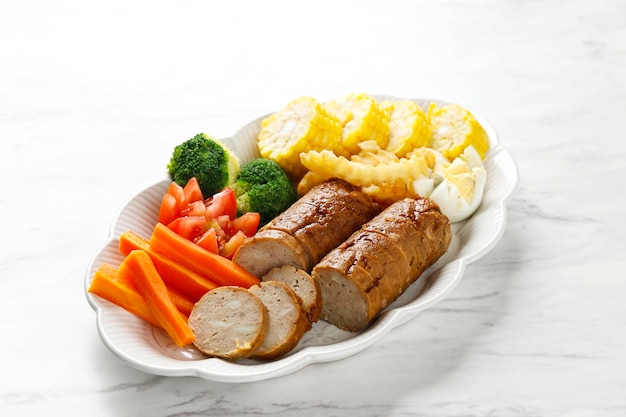 Meatloaf with Mushroom Glaze Sliced on a Plate Ground Beef and Chicken Dish Served with Steamed Vegetable on White Table