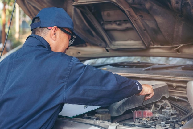 Mechanic car service auto garage in automotive mobile center Technician workshop repair engine motor vehicles service mechanical engineering business Automobile mechanic hands car repairs technic