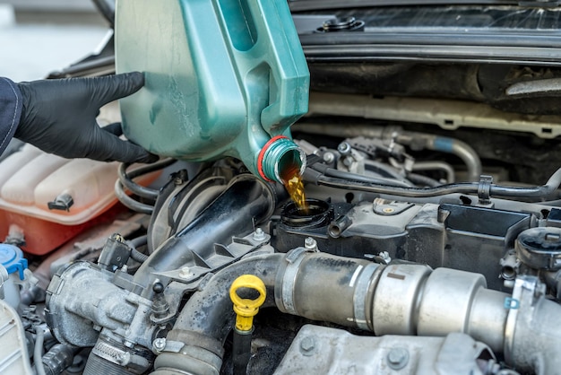 Mechanic change oil to engine, car servicing. vichile repair