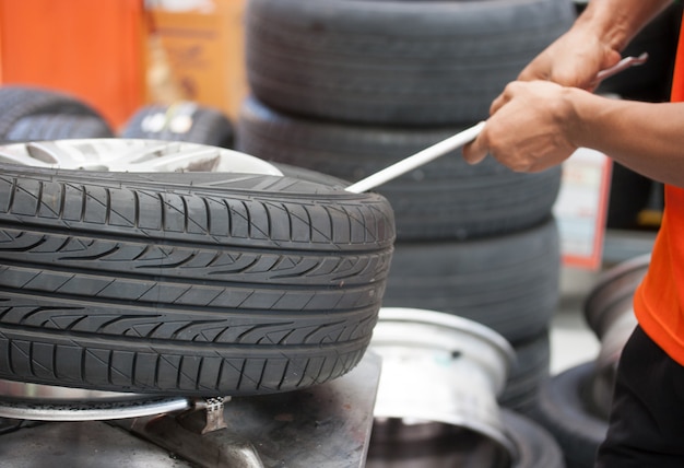 Mechanic changing car tire closeup