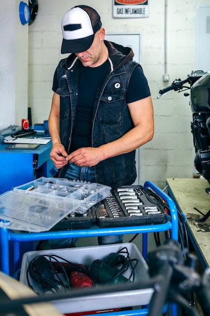 Mechanic choosing screws from a tool box