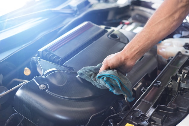 Mechanic cleaning car engine