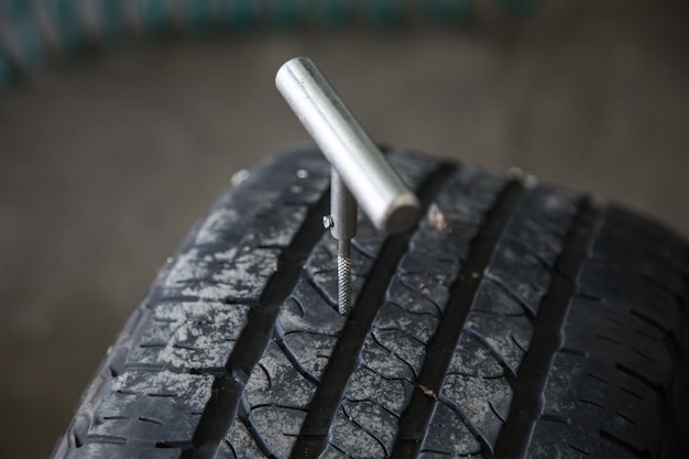 Mechanic closes a hole in a tire in a workshop