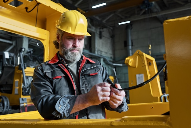 Mechanic connecting the equipment in workshop