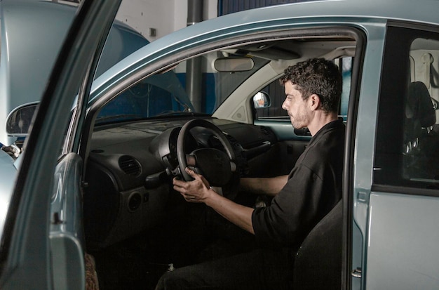 Mechanic doing tests inside the car