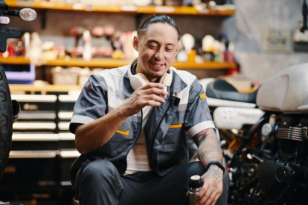 Mechanic drinking coffee during break