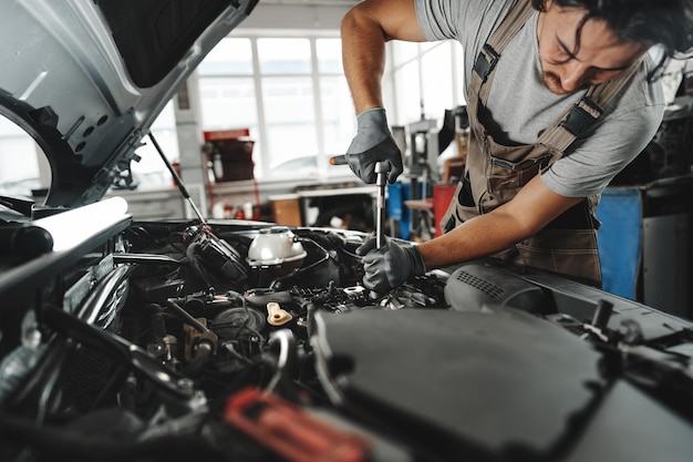 Mechanic examining car in auto car repair service center