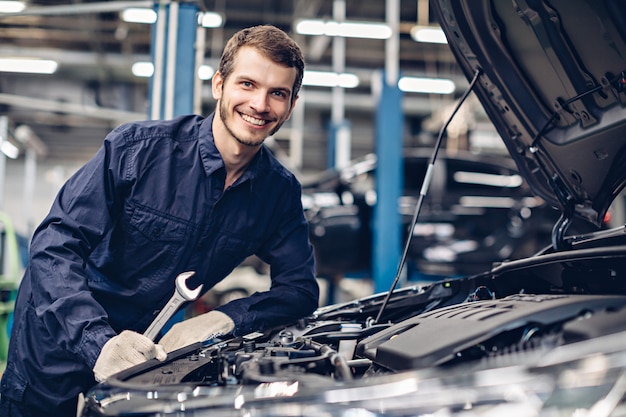 Mechanic examining car engine