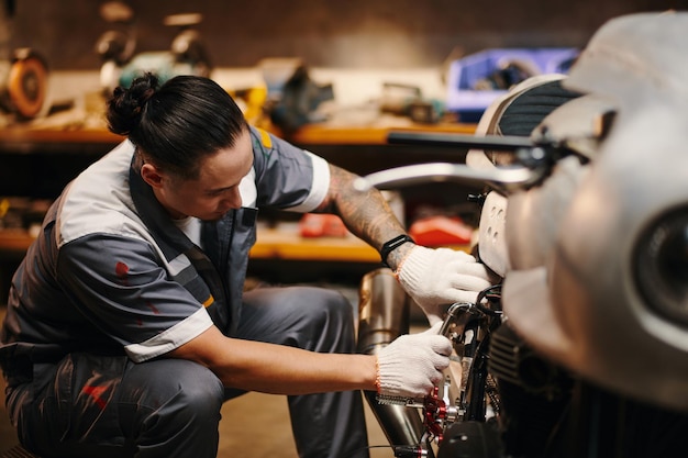 Mechanic fixing broken motorcycle