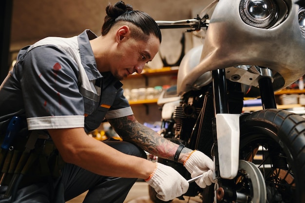 Mechanic fixing motorcycle wheel