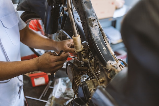 Mechanic fixing motorcycle