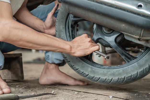 mechanic hand repairing tire