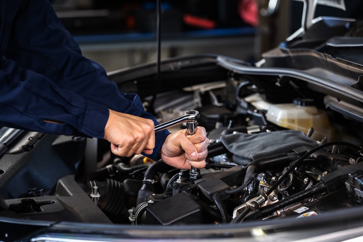 Photo mechanic hand using wrench to repair engine, car service