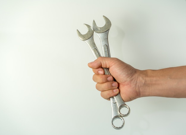 Mechanic holds spanner tools 