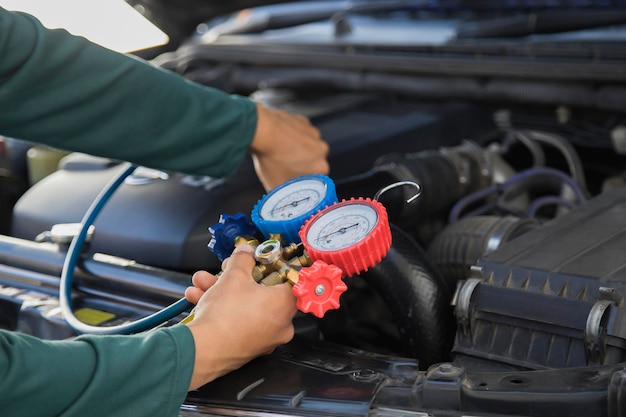 A mechanic is checking the temperature of a car