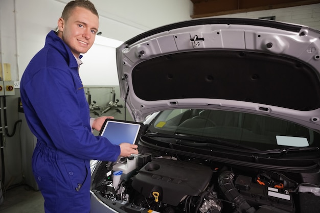 Photo mechanic looking at camera while holding a tablet computer