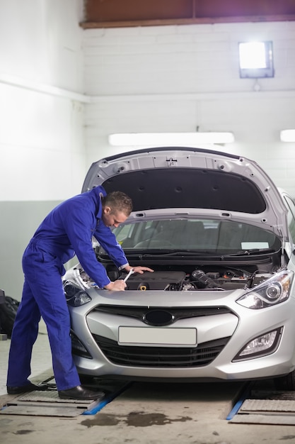 Mechanic looking at the car engine