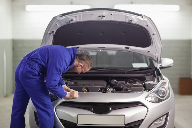 Mechanic looking at an engine