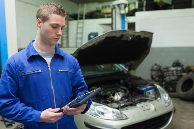 Mechanic looking at tablet pc