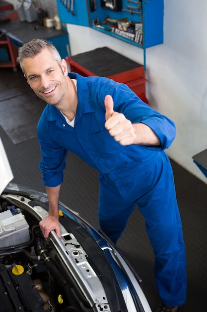 Mechanic looking up at camera