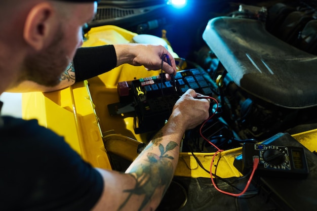 Mechanic of maintenance service carrying out technical diagnostics