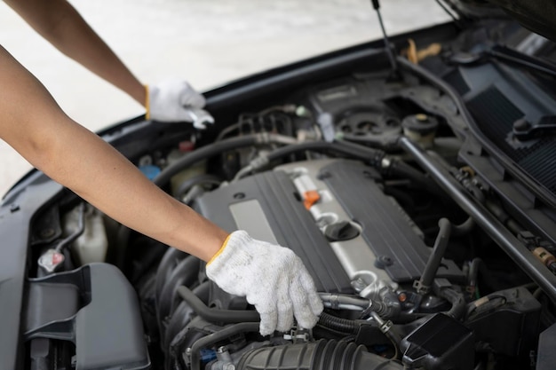 Mechanic man fixing car engine in the garage