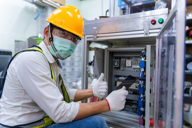 Mechanic man wearing protective mask while working