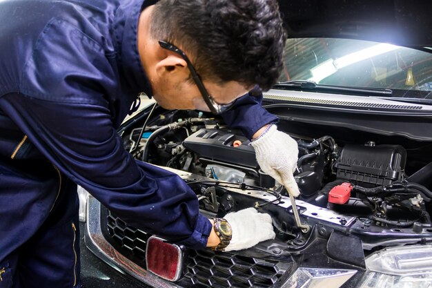 Photo mechanic repairing car in auto repair shop