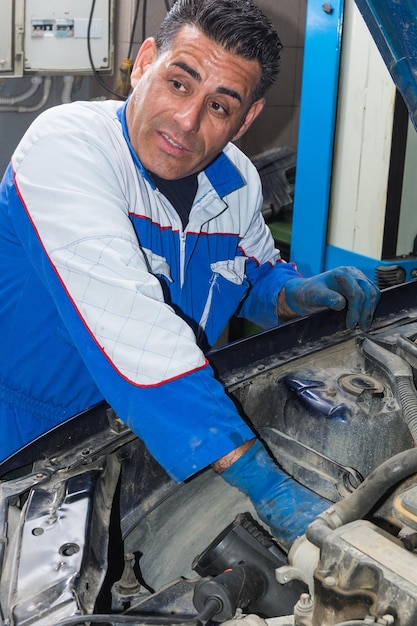 Mechanic repairing car at workshop