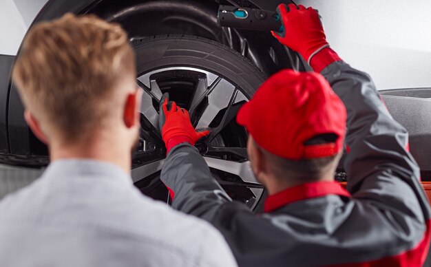 Mechanic repairing car in workshop