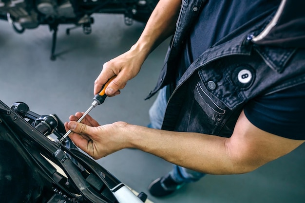 Mechanic repairing customized motorcycle