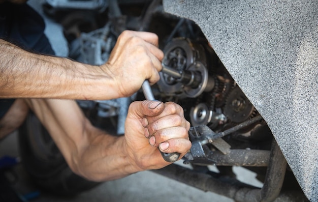 Mechanic repairing engine of motorcycle Concept of motorcycle maintenance